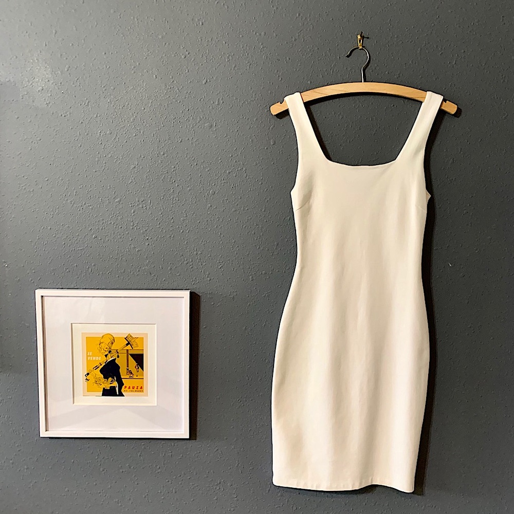 White stretchy figure hugging shift dress.